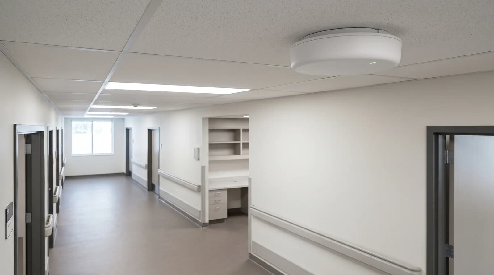 A ceiling-mounted indoor cellular unit in a healthcare corridor